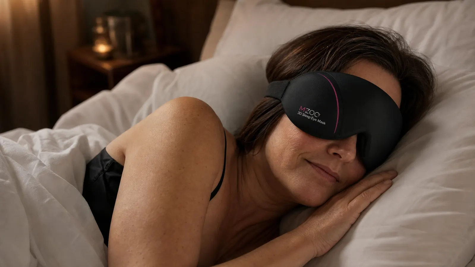 Person wearing the MZOO eye mask while lying on their side in bed, fully relaxed