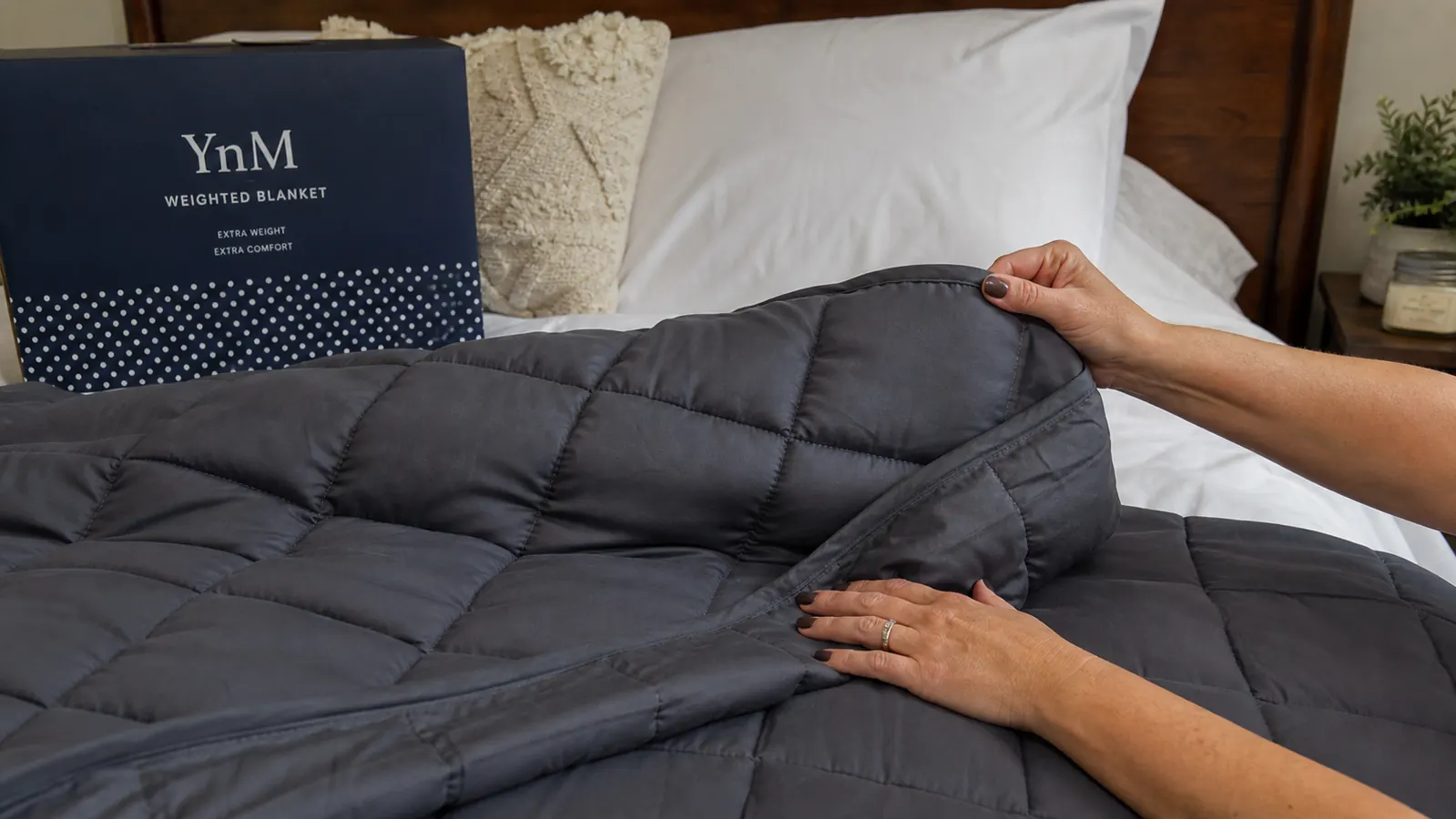 YnM weighted blanket laid flat showing the small glass-bead grid squares across the surface